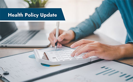 Person using a calculator at a desk with a laptop and charts, alongside a banner reading "Health Policy Update."